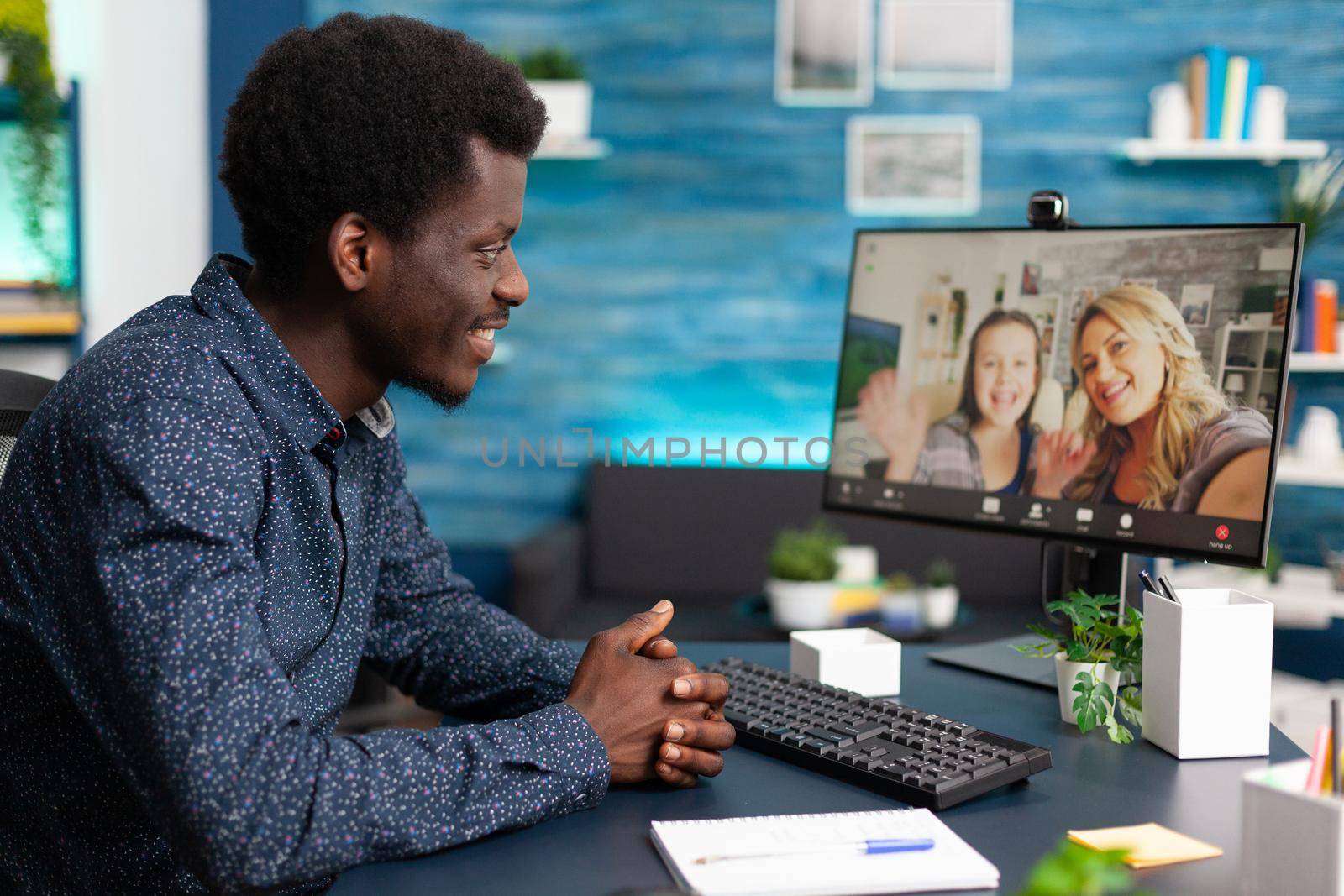 Black man talking with friends and family on video call using webcam and communication. African american person chatting on online conference from home office for social distancing