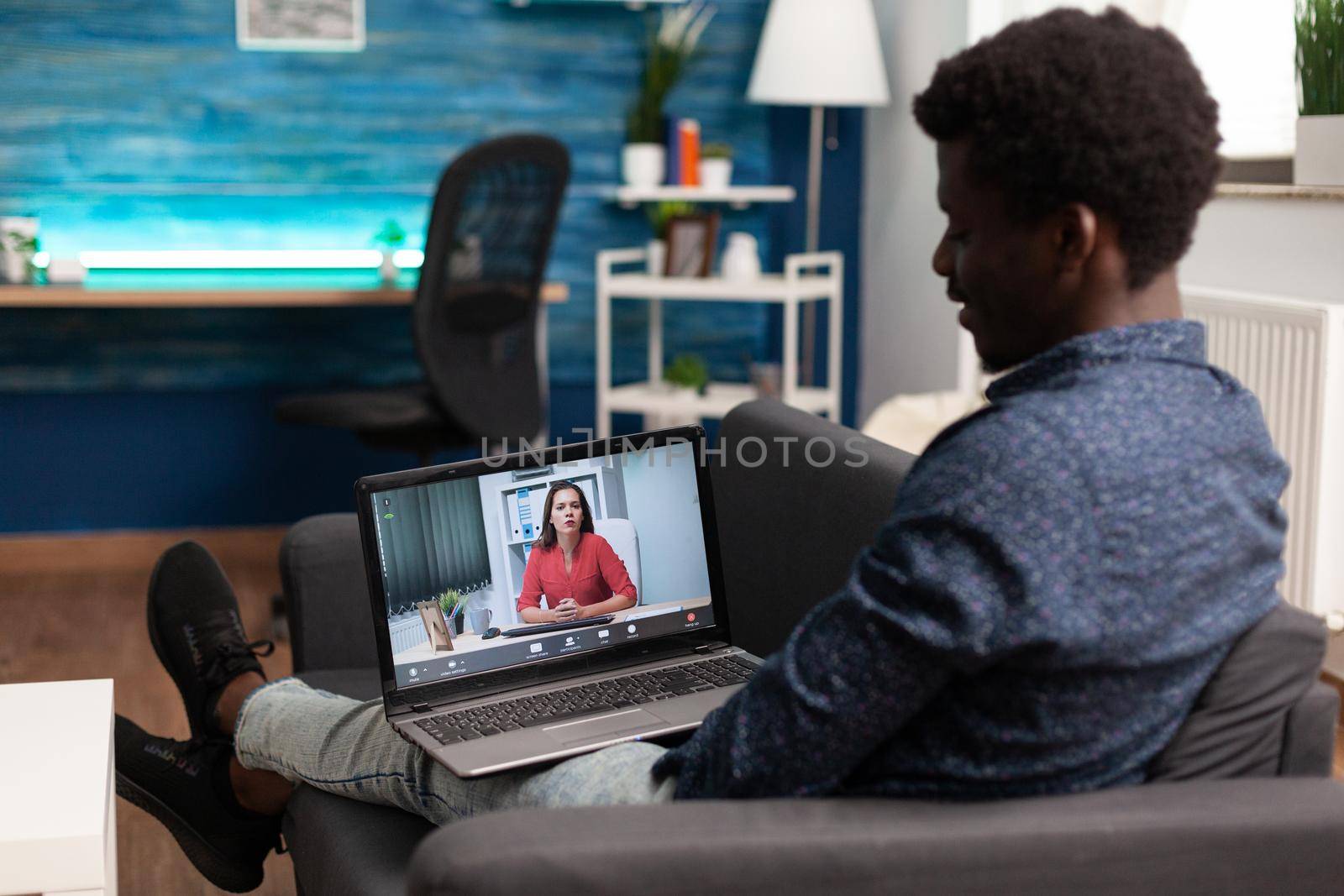 Black remote person working from home on video call talking on online internet conference with woman coworker. African american man on website teleconference, using computer device