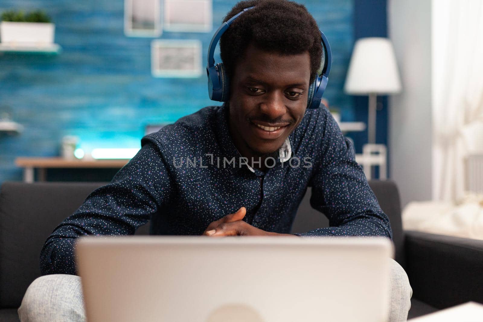 Black man using headphones and laptop technology by DCStudio