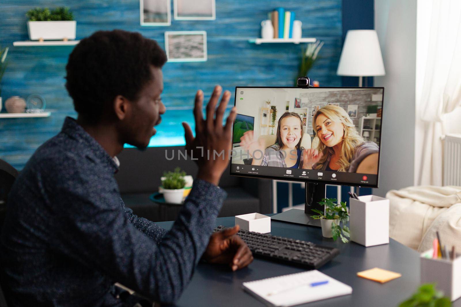 African american man talking on online video call with family and friends using webcam. Black man using digital internet conference from home office for virtual chat communication