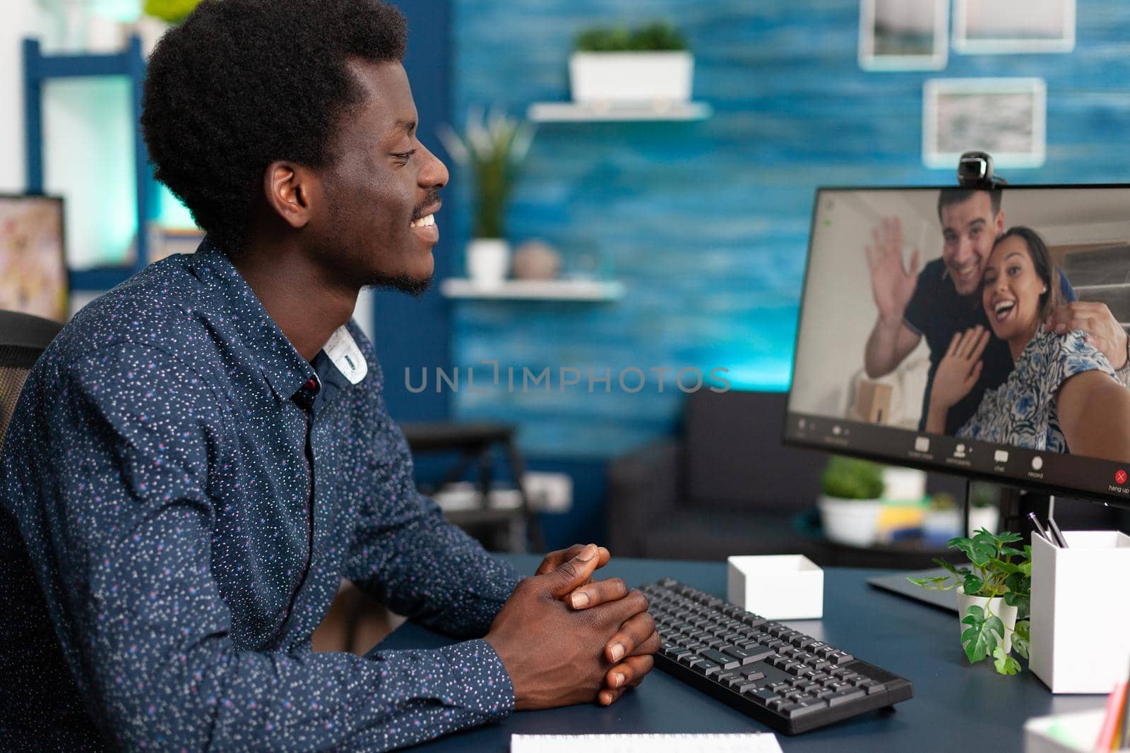 Black person on online video call conversation talking with friends and family using webcam technology and internet on computer. African ethnicity man chatting from home apartment