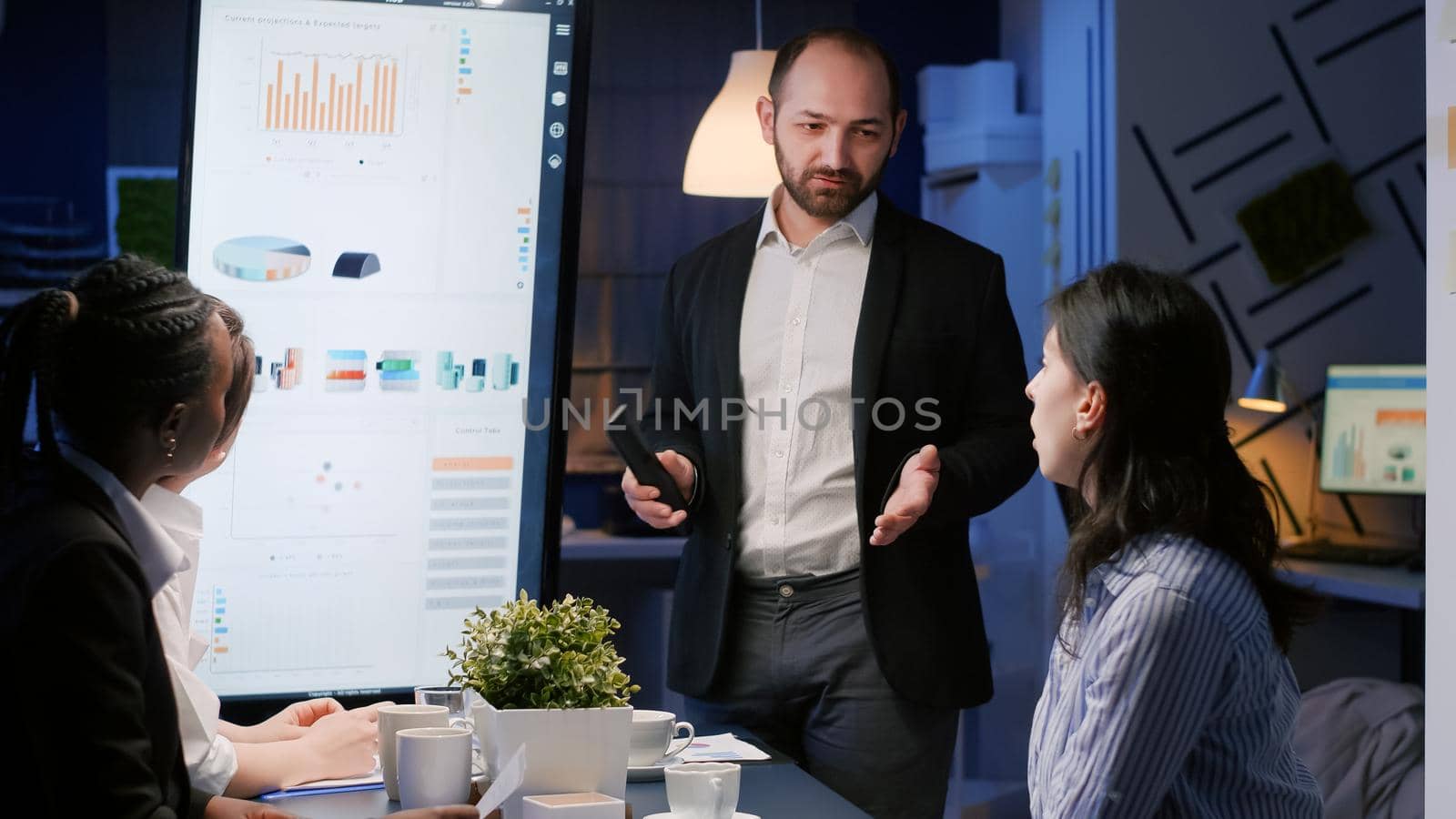 Focused executive manager man explaining management strategy using presentation monitor by DCStudio