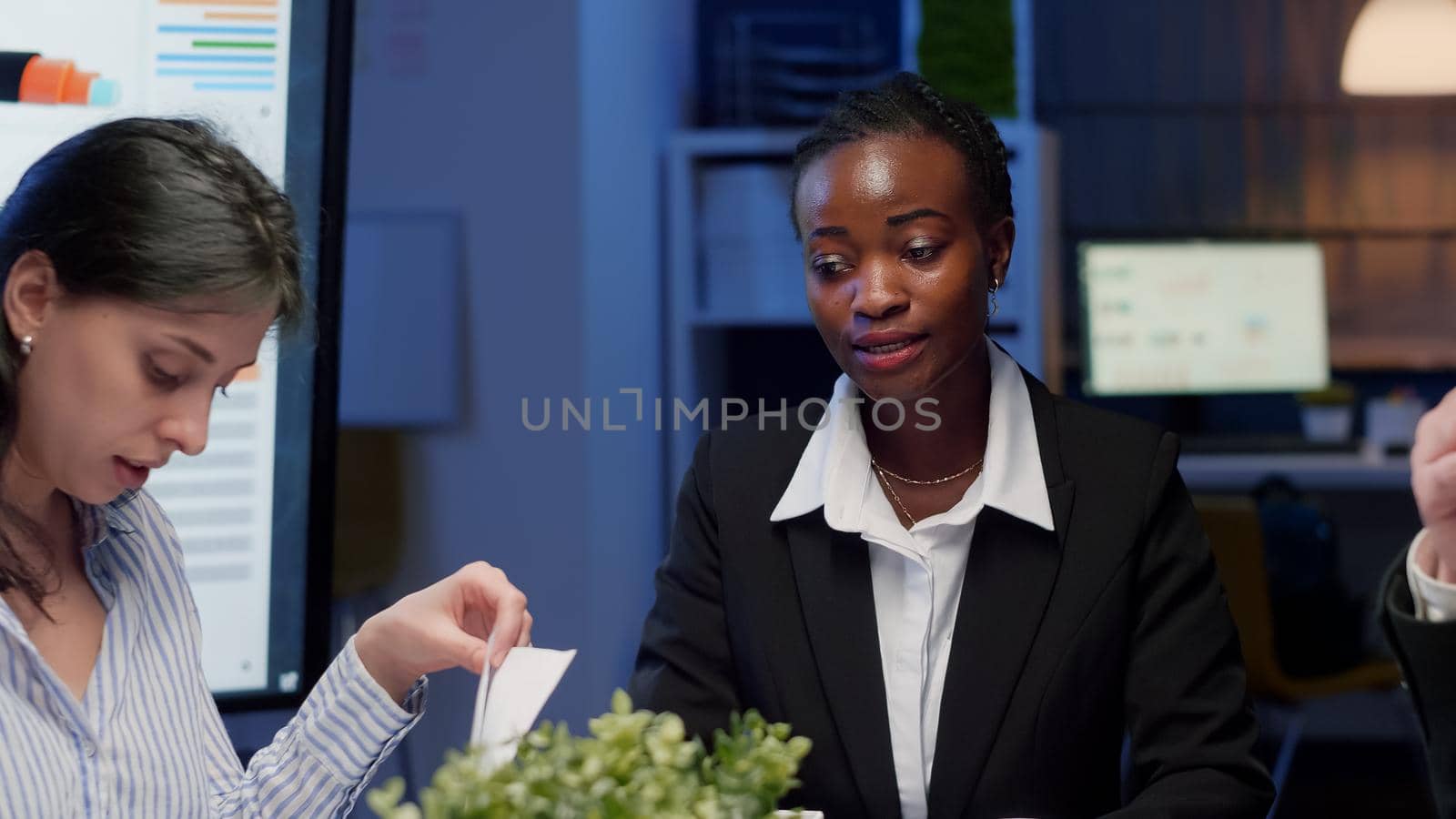 African american businesswoman brainstorming business strategy working in meeting room by DCStudio