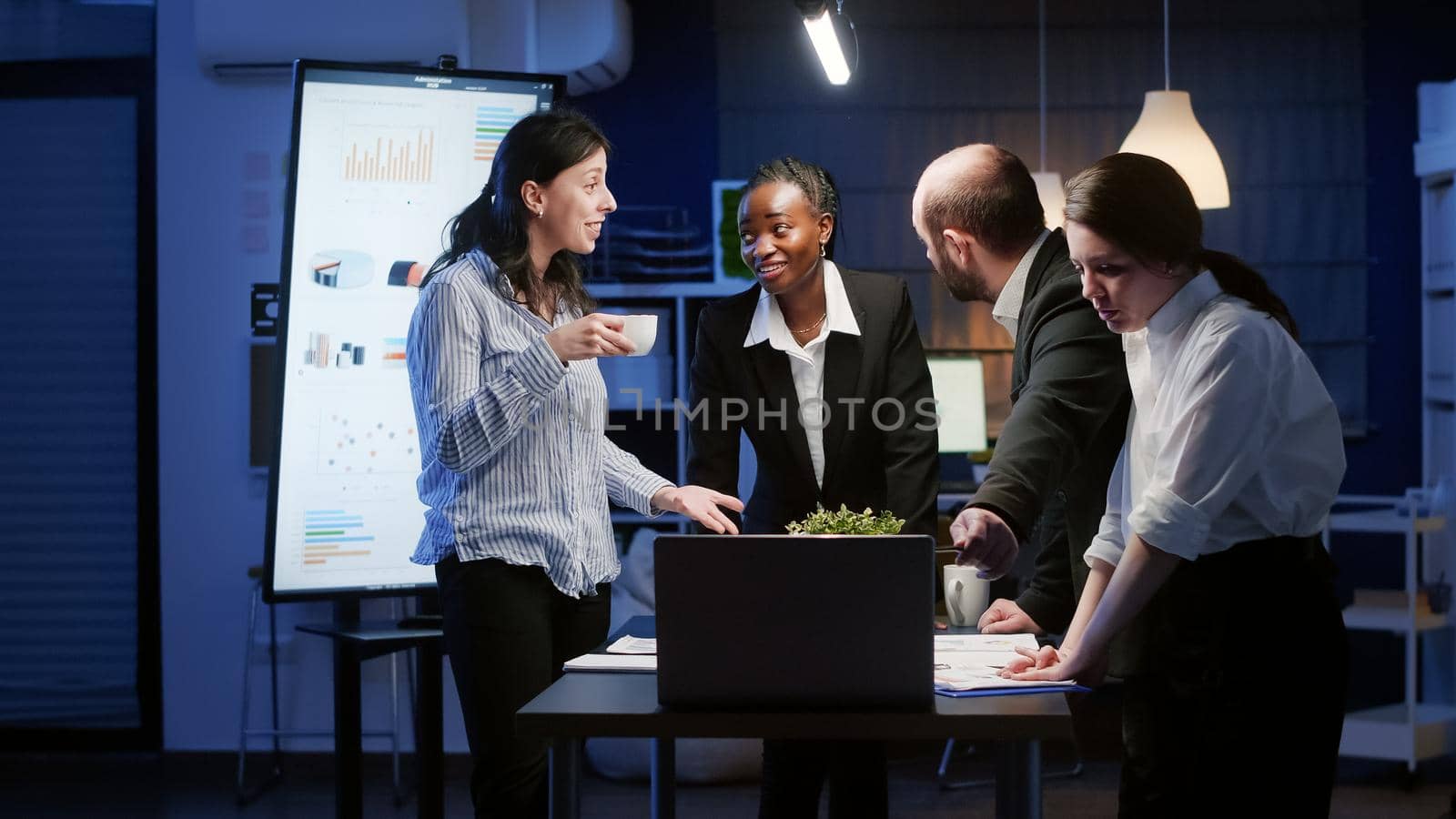 Excited diverse business teamwork receiving good news clapping while standing at table by DCStudio