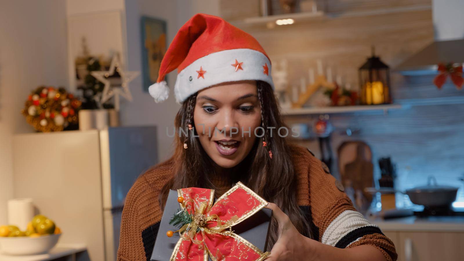 Cheerful caucasian woman opening presents from friends by DCStudio