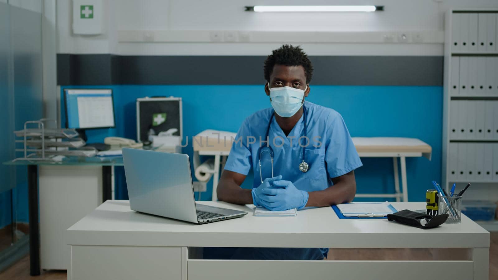 Portrait of young person working as nurse in cabinet by DCStudio