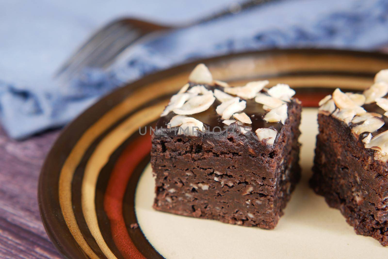 slice of brownie on plate on table .