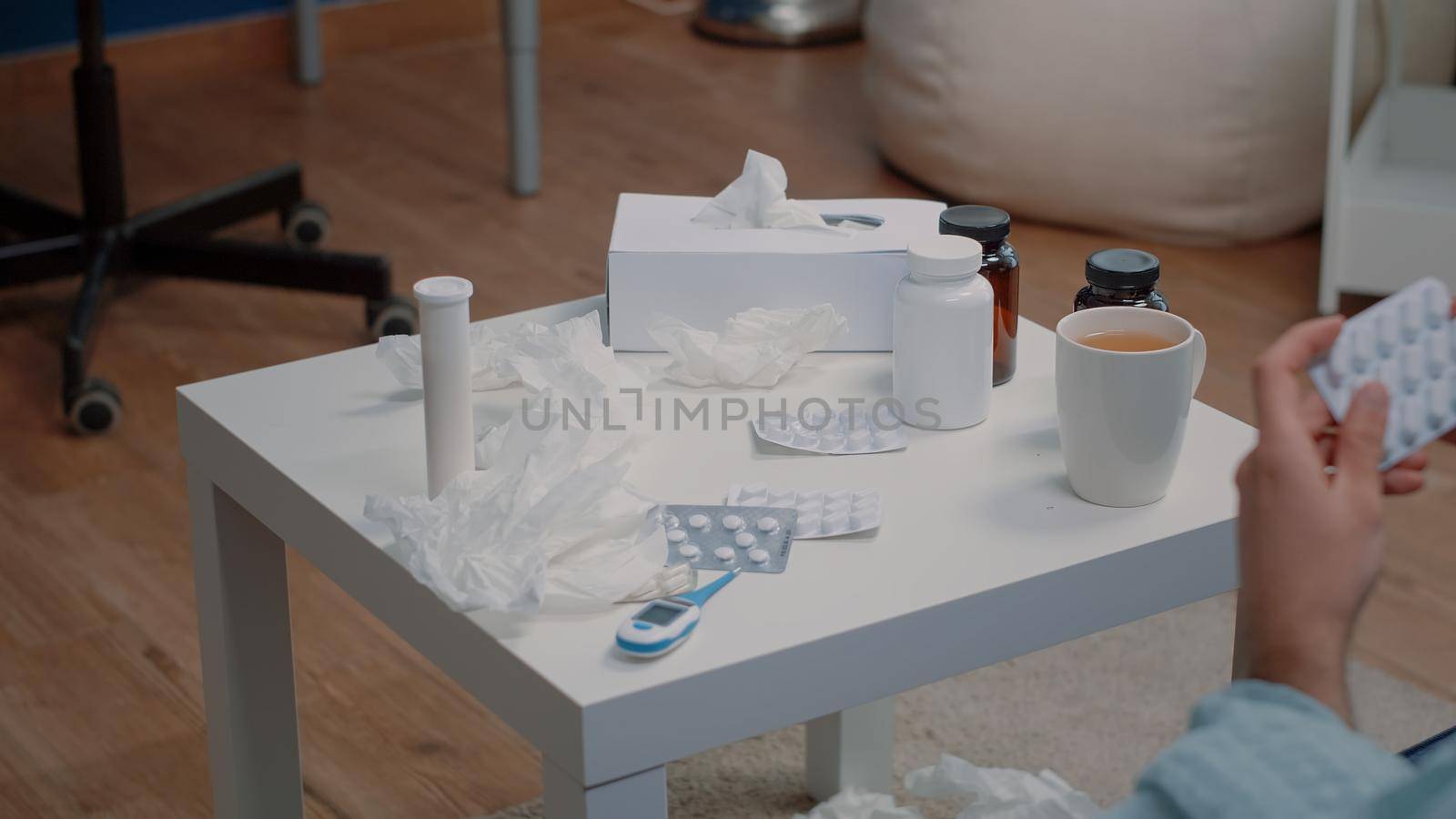 Close up of hand holding tablets of capsules for treatment by DCStudio