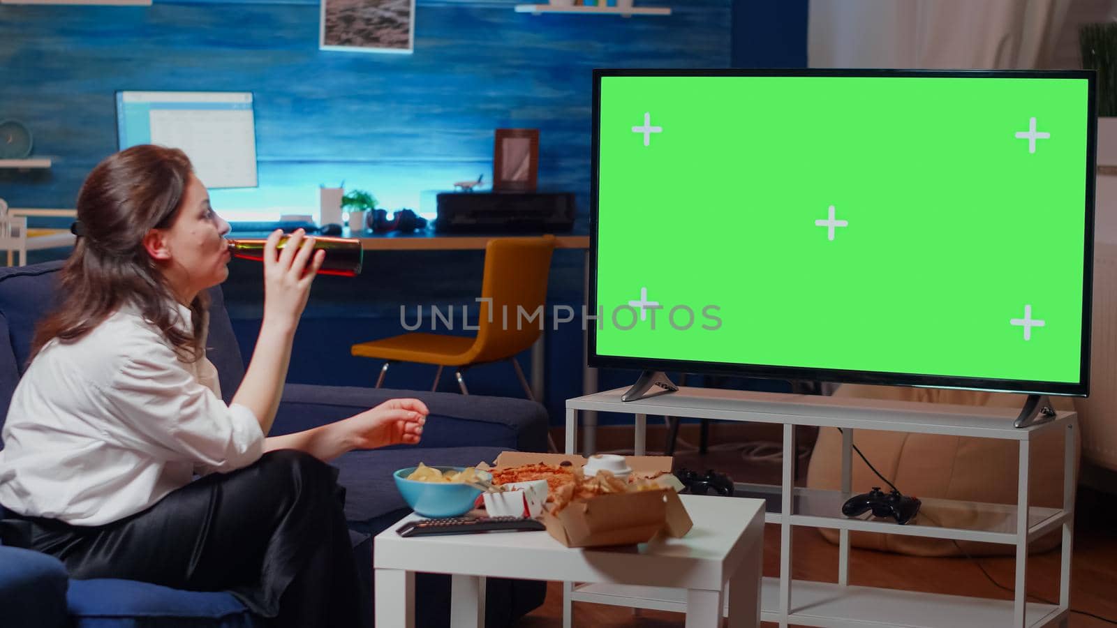 Caucasian woman watching green screen on television by DCStudio