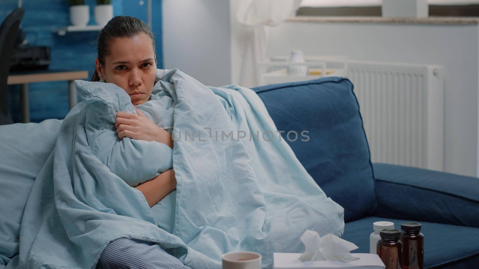 Unhappy woman shivering because of cold and flu by DCStudio