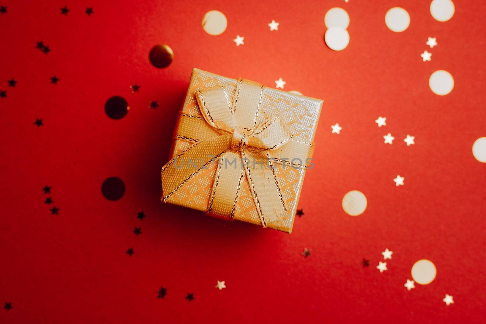 Yellow New Year gift . New Year and Christmas. Copy space. An article about choosing a gift. Red background