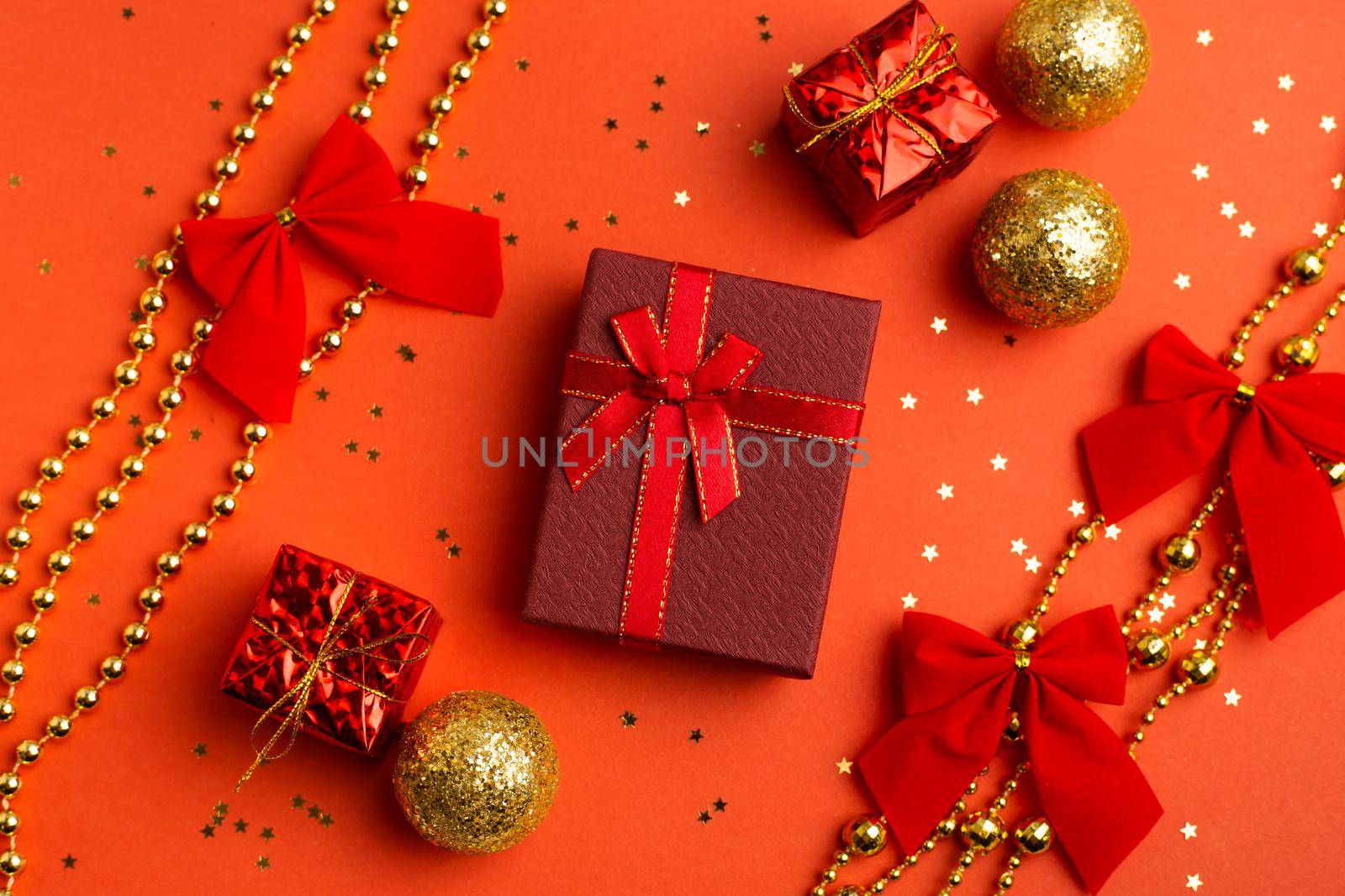 Red Christmas gifts and Christmas trees on a red background. An article about the New year and Christmas. The choice of gifts. A red gift . New Year's background