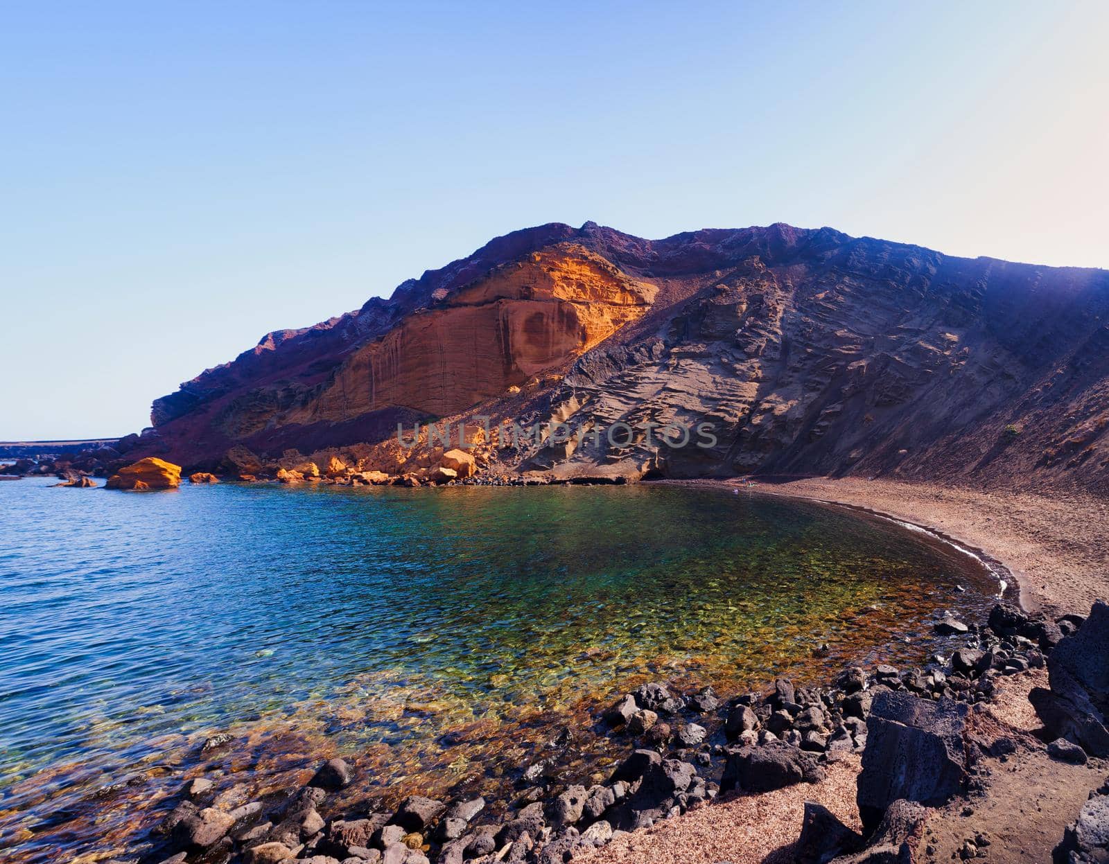 View of the Linosa volcano called Monte Nero in the beach of Cala Pozzolana di Ponente, Sicily