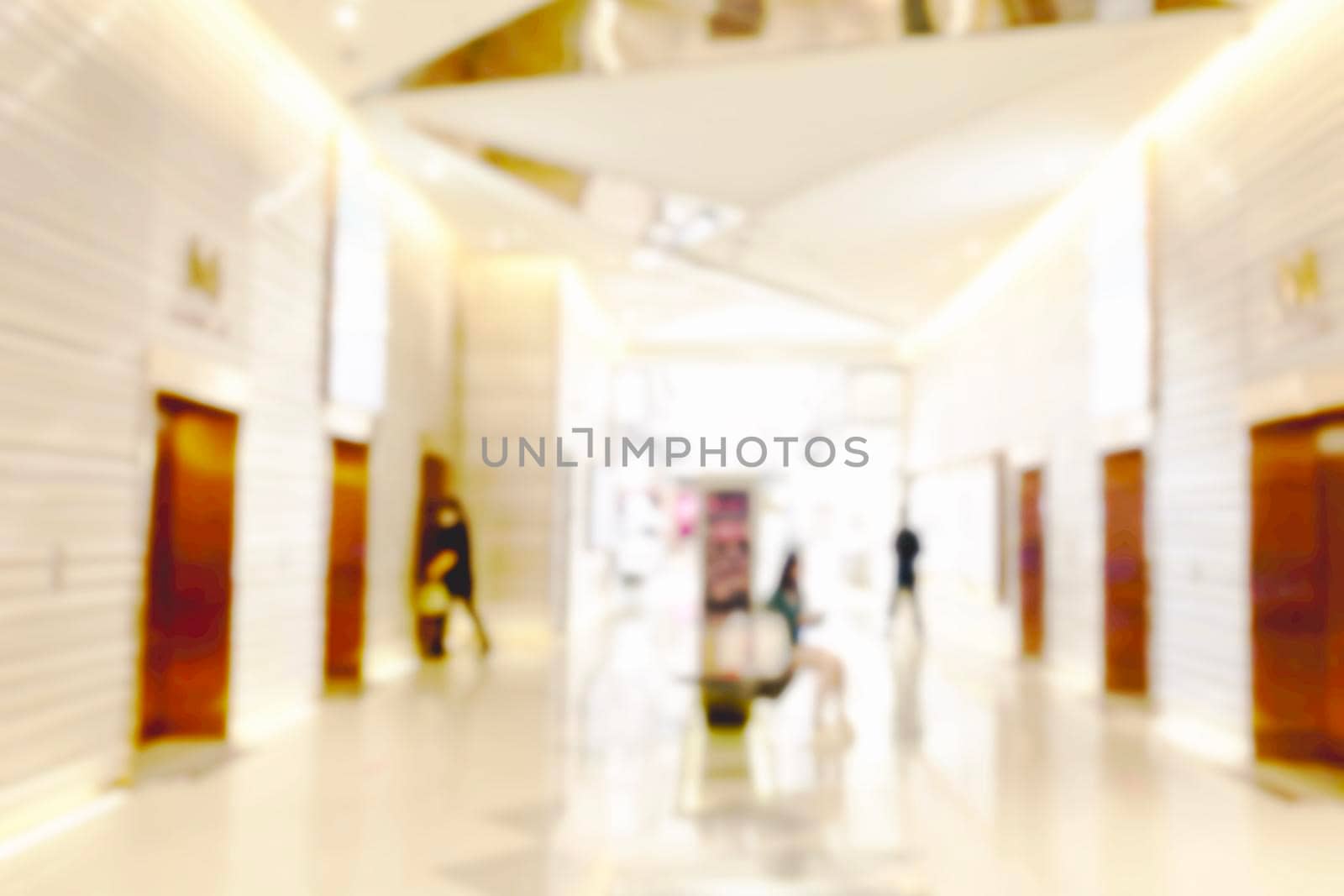 Blur light background at shop in mall for business background, blurry abstract bokeh at interior hallway.