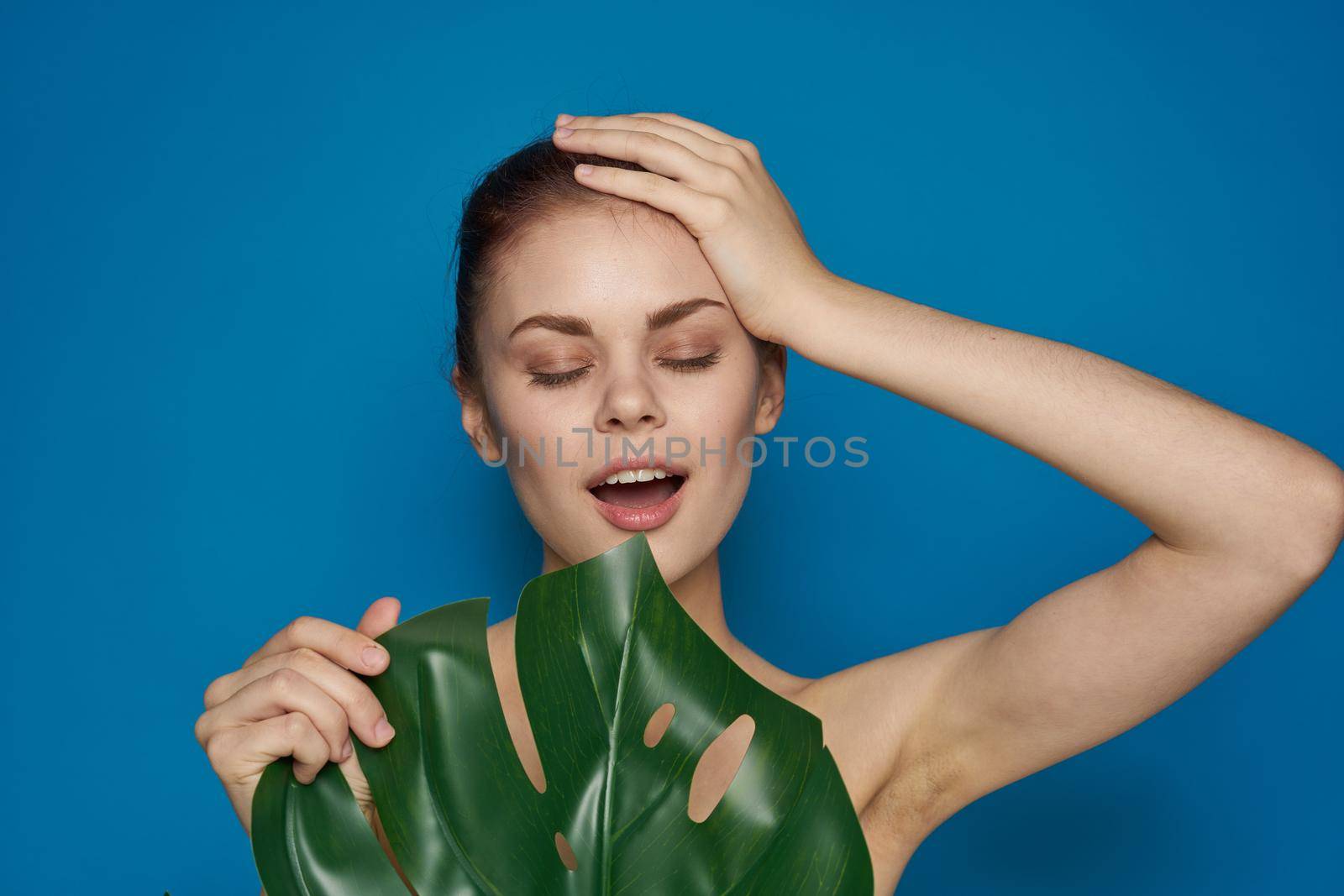 beautiful woman clean skin palm leaf cosmetics isolated background by Vichizh