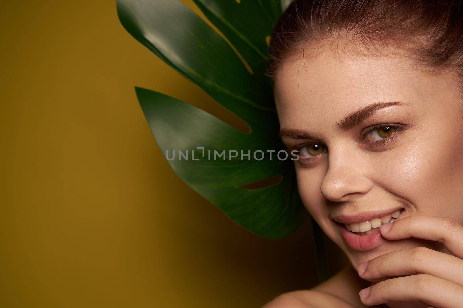 pretty woman bare shoulders red lips posing yellow background by Vichizh