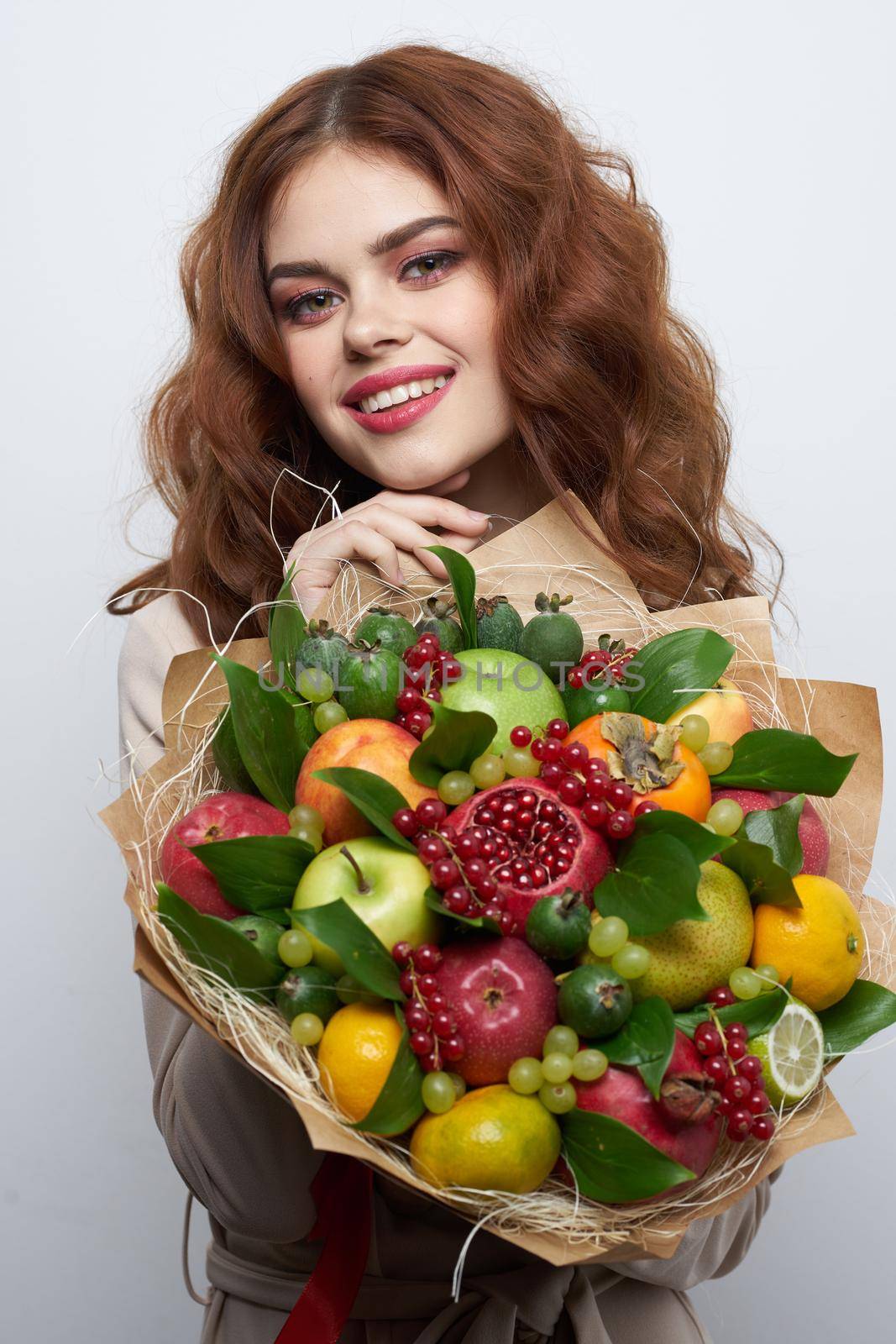 beautiful woman fashionable hairstyle bouquet of flowers decoration light background. High quality photo