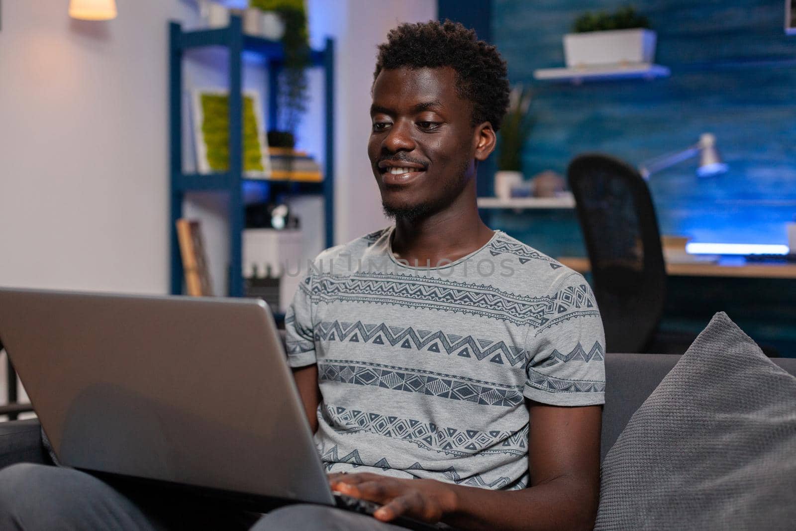 African american young freelancer working remote from home at management project using laptop computer. Black entrepreneur man browsing online communication information. Business project