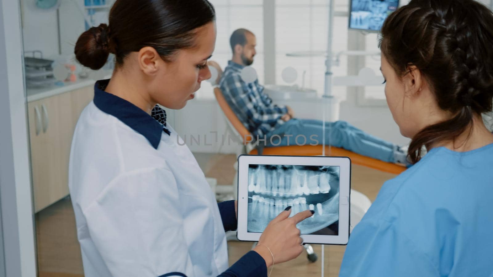 Stomatologist holding modern tablet with x ray on screen by DCStudio