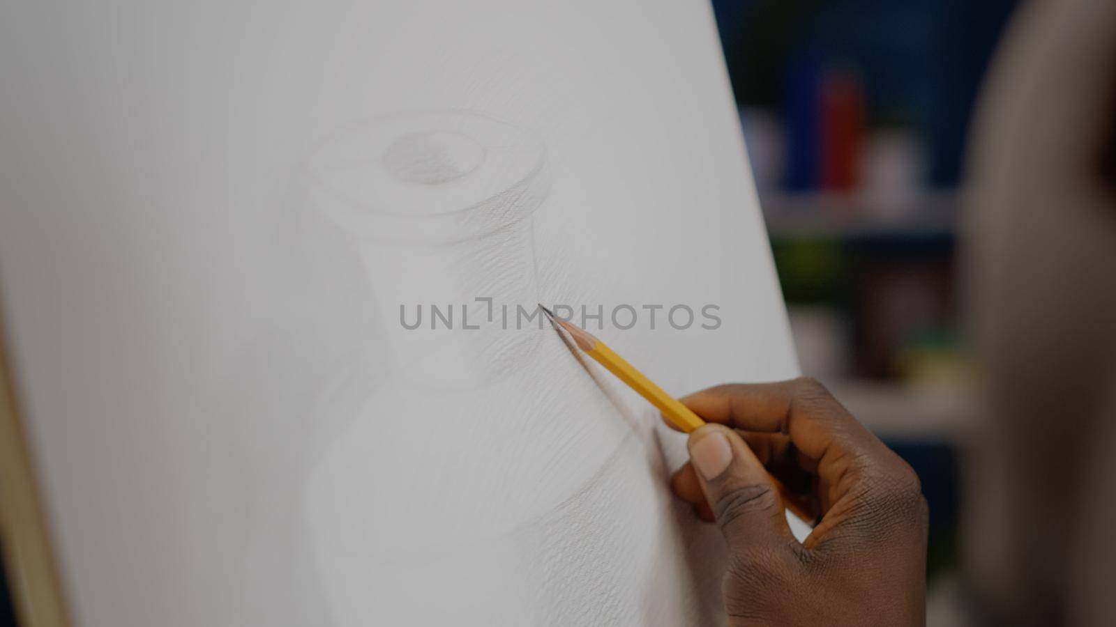 Close up of white canvas with vase drawing and black hand holding pencil for authentic design at studio. African american artist using art tools and instruments for innovative masterpiece