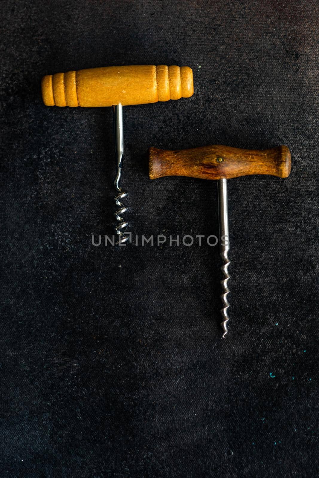 Vintage corkscrew on textured  rustic background