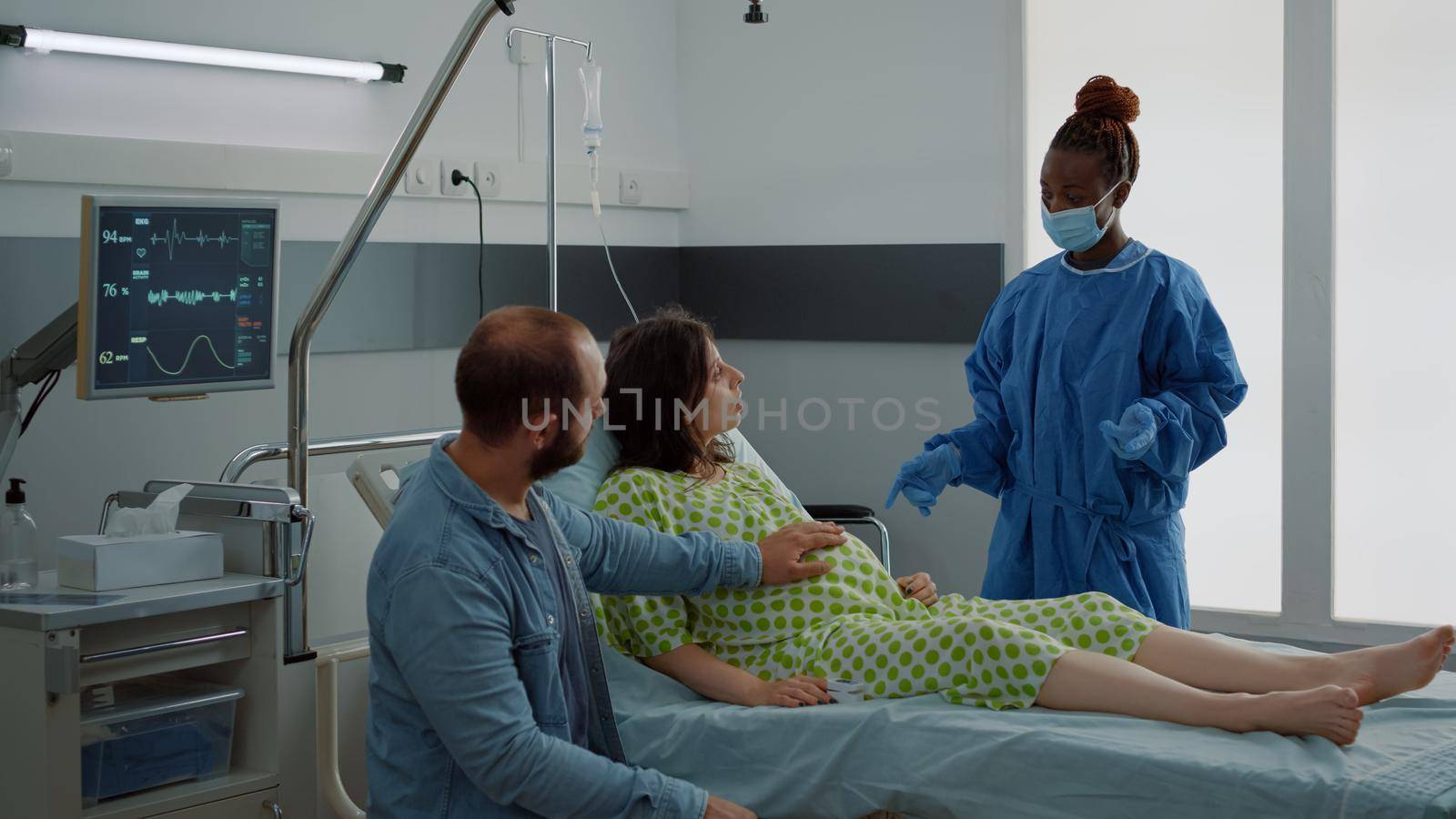 Caucasian couple expecting baby in maternity ward by DCStudio