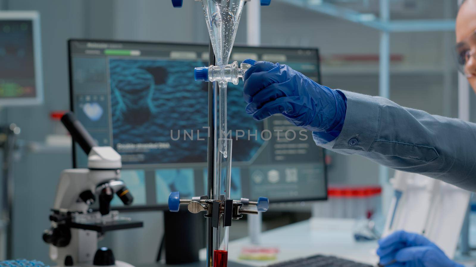 Science specialist using chemical test tube in laboratory on desk with research equipment. Doctor operating dripping pipe mixing fluid solutions in glassware for pharmaceutical innovation