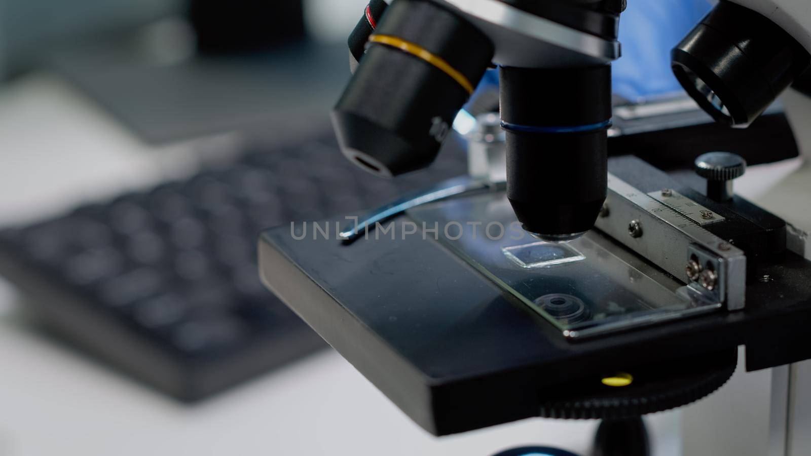 Close up of glass tray on microscope for examination by DCStudio