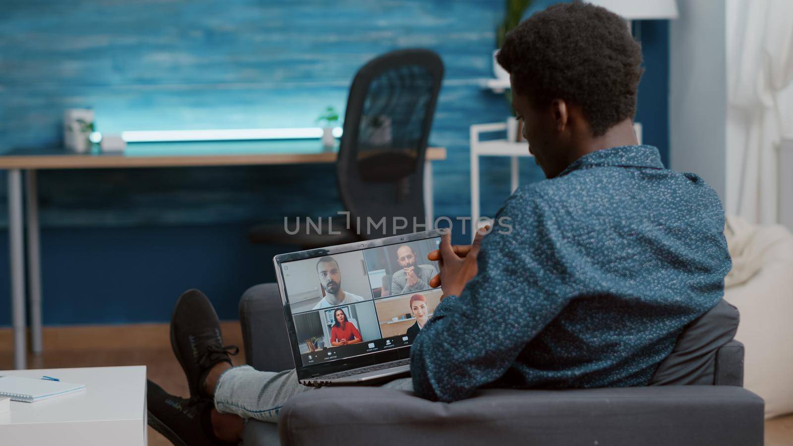 African american man using laptop for online internet conference chat with his coworkers, remote working from home, teleconference web communication with webcam. Black guy distance technology talking