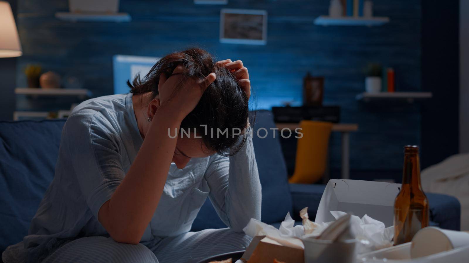 Close up exhausted frustrated depressed young woman massaging temples having mental problems. Stressed unhealthy lonely person feeling tired suffering from migraine, bipolar disorder, major depression