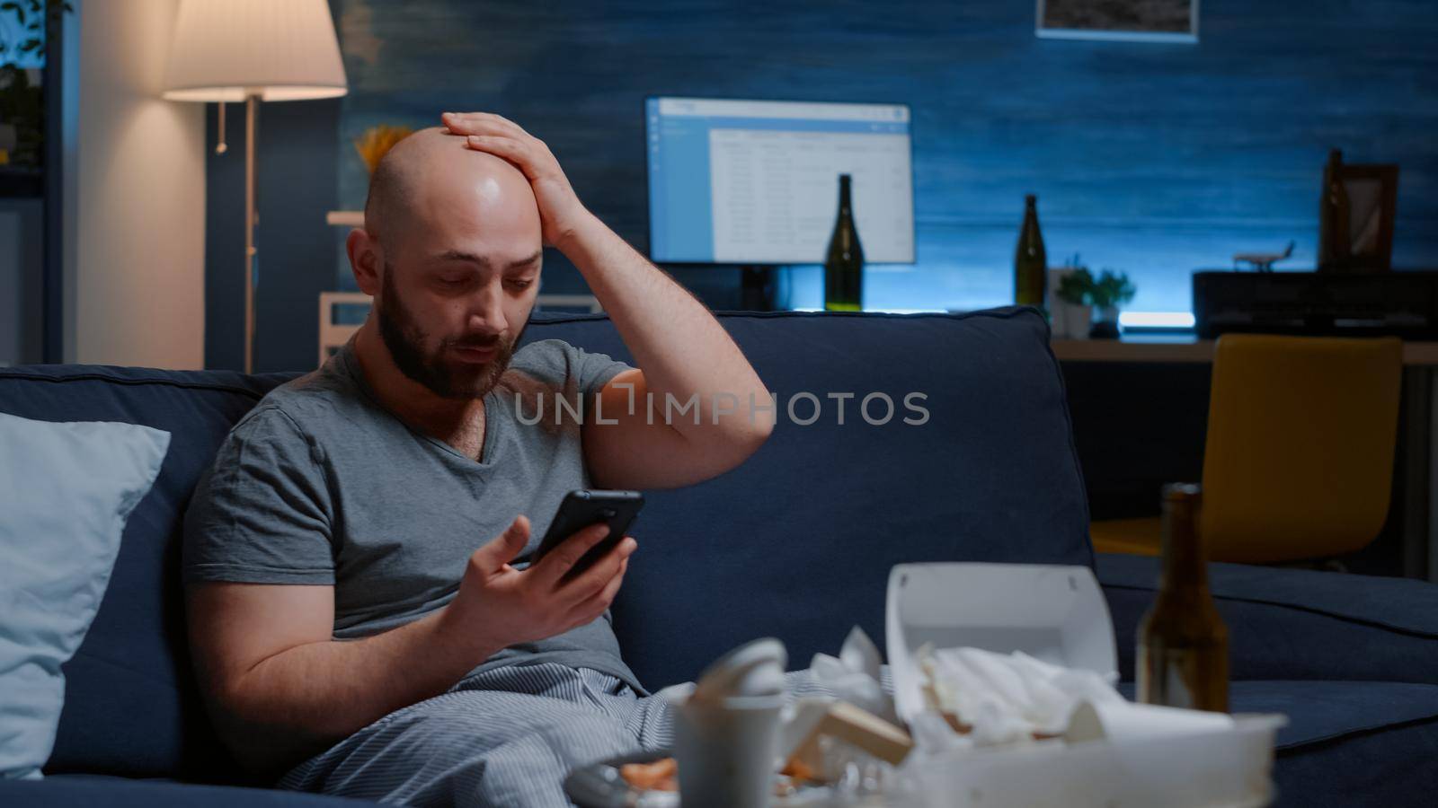 Shocked, worried man by warning notification for unpaid bank bills received on smartphone putting hands on head crying. Disappointed, frustrated, annoyed desperate male reading digital eviction notice