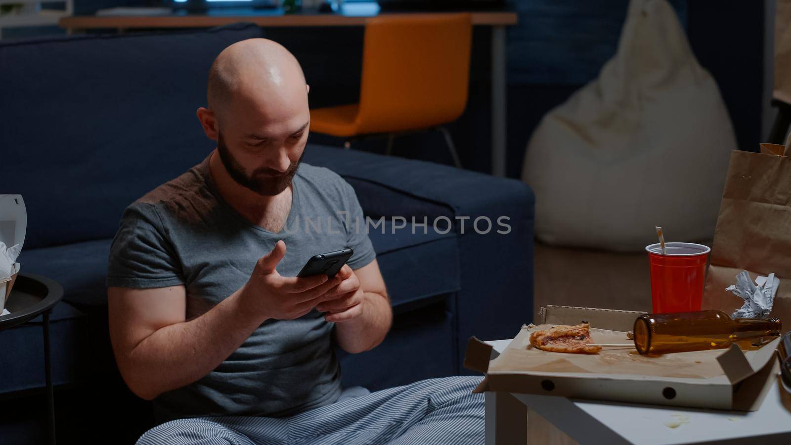 Shocked, worried tenant by receving notification on smartphone for unpaid invoices, eviction notice. Disappointed, frustrated, annoyed desperate man putting hands on head crying reading mail