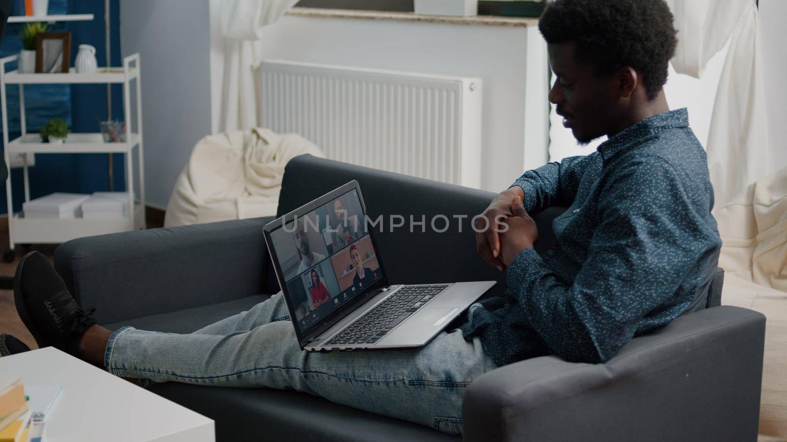 African american ethnicity man using online conference webcam communication to connect via internet with coworkers while working from home. Black man remote worker chatting, communication video call