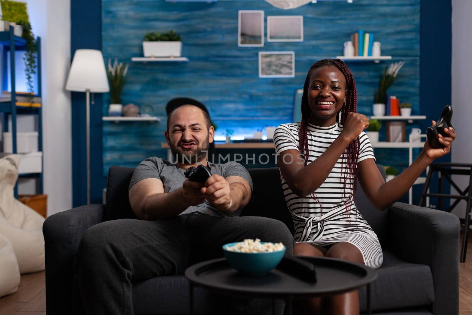 Cheerful interracial people winning video game on TV by DCStudio