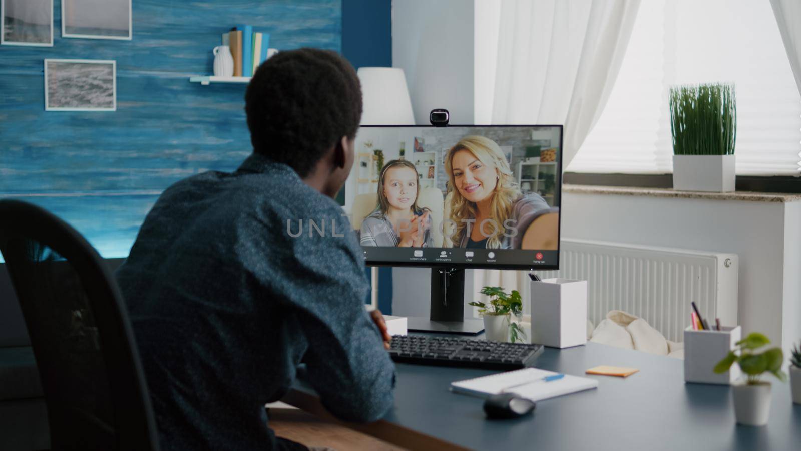 African american man talking with friends and family using online video call communication and webcam. Black man video conference from home office, remote intenet chat conversation