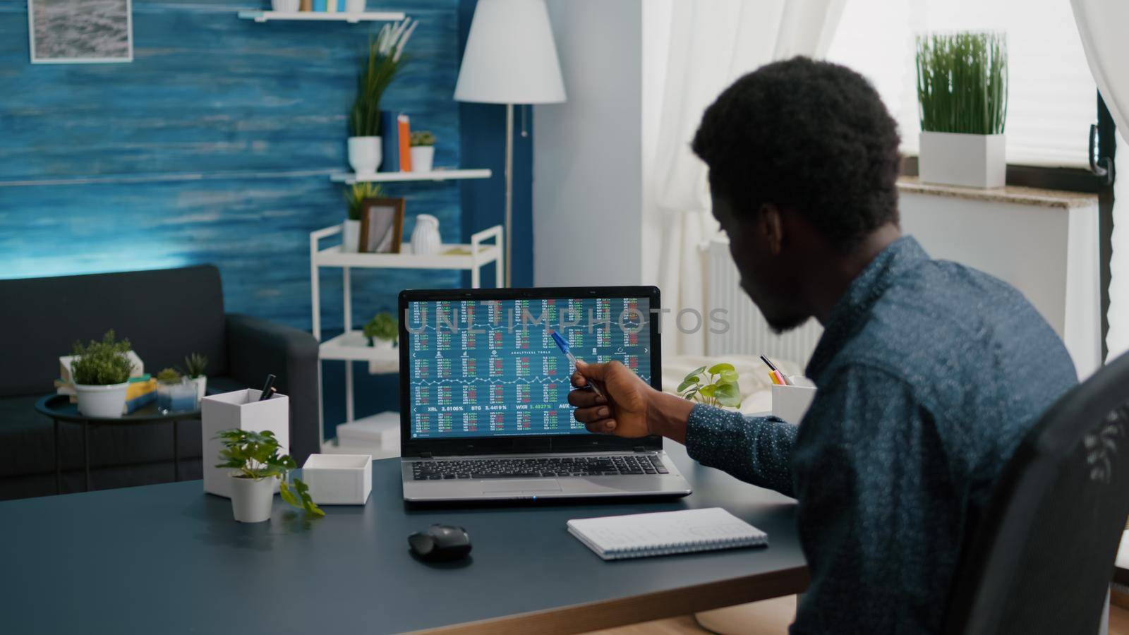 African american man crypto currency stock markets trader checking stock ticker index, deciding to buy or sell digital coin money. Balck guy watching bitcoin charts forex investment finance exchange