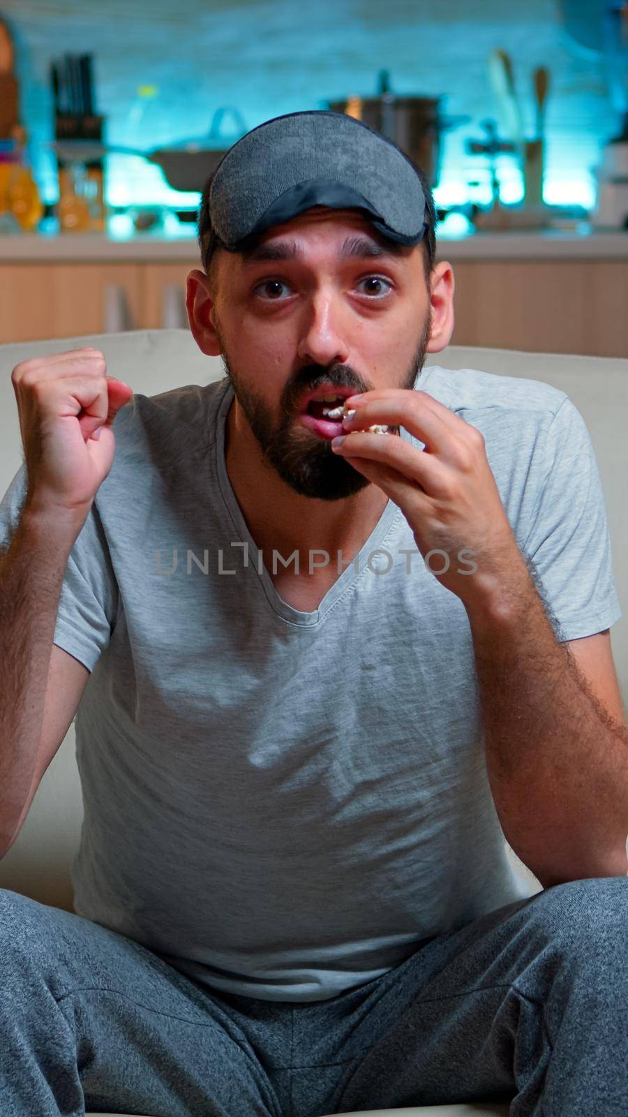 POV Upset sport fan cause his team looses the championship, watching game night on TV alone in living room. Disappointed expressive angry defeat caucasian man watching television