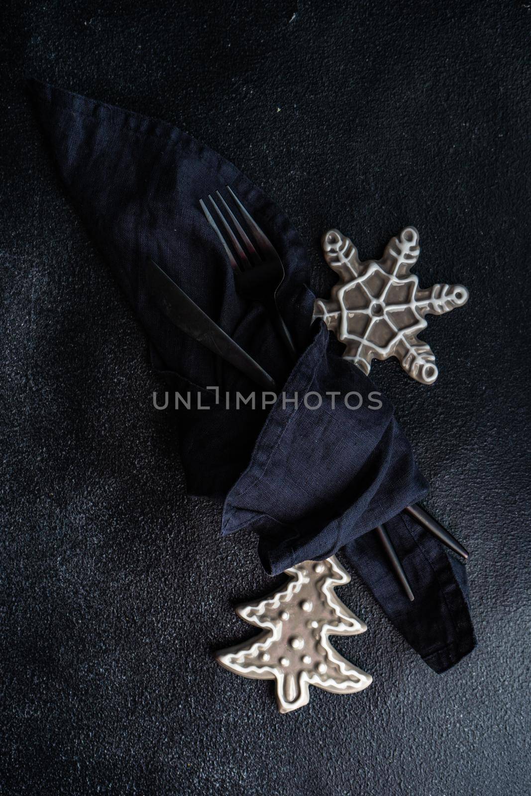 Holiday table setting for Christmas dinner on dark background