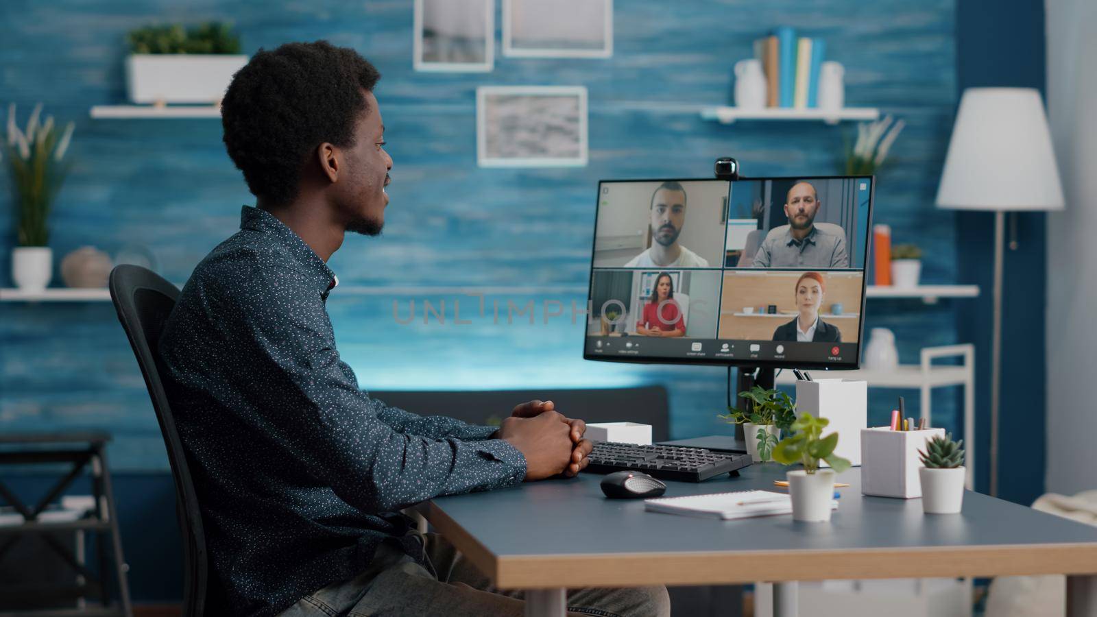 African american man on online internet conference chat with his coworkers, remote working from home, using teleconference web communication with webcam. Black guy distance technology talking