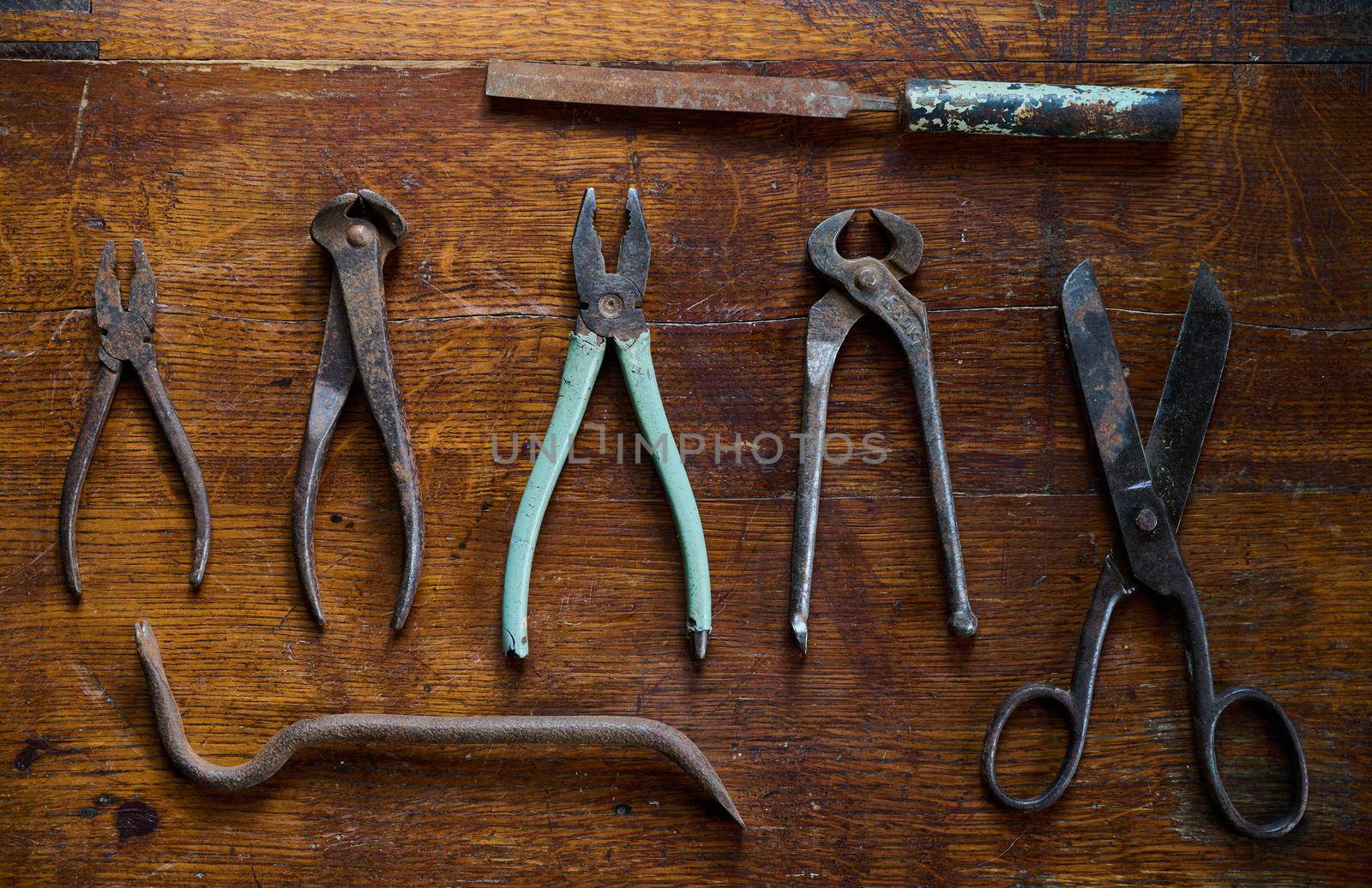 knoling with old and rusty tools on a vintage table made of lacquered wood view from the top