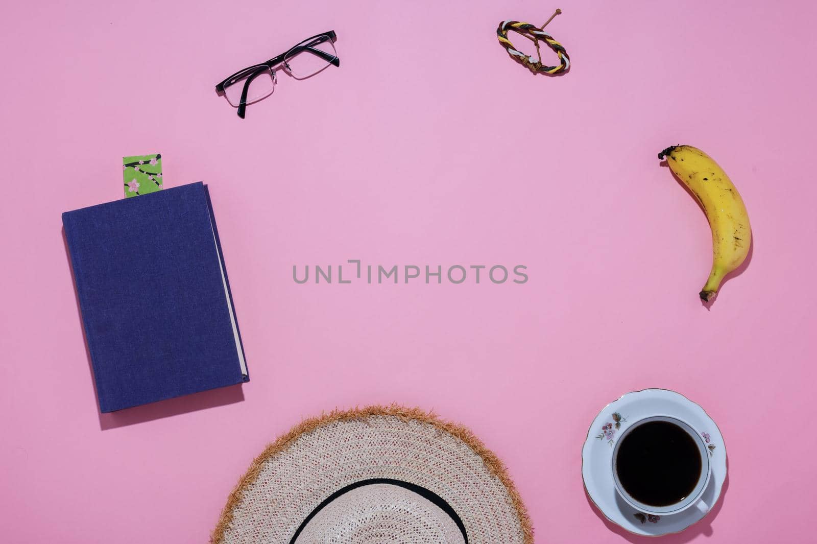 close-up of travelers' personal belongings pink background by ISRAFOTO