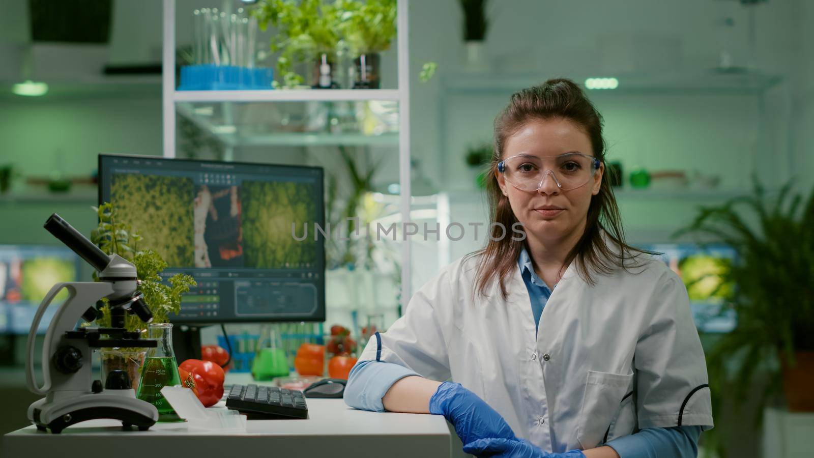 Pov of biologist researcher woman with medical equipment analyzing with biologits team during online videocall meeting while sitting in botanic scientific lab. Specialists researching genetic mutation