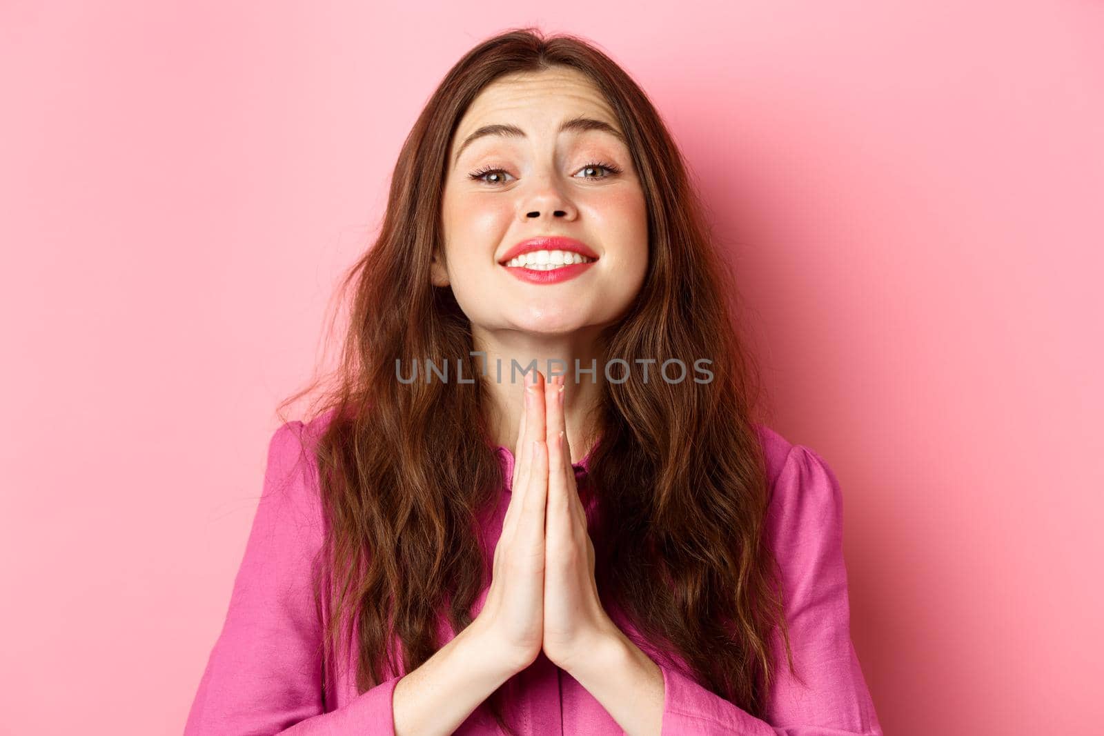 Close up portrait of cute young girl asking for favour, begging you, say please and show pleading gesture, standing over pink background by Benzoix