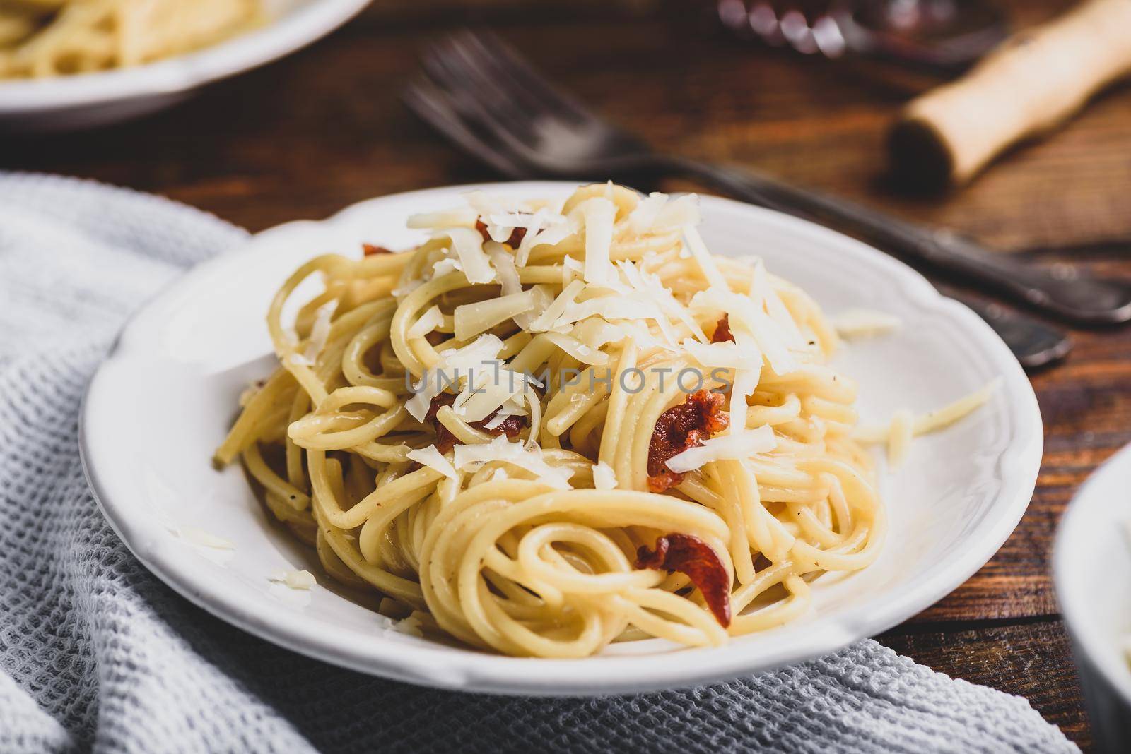 Homamade classic carbonara pasta on white plate