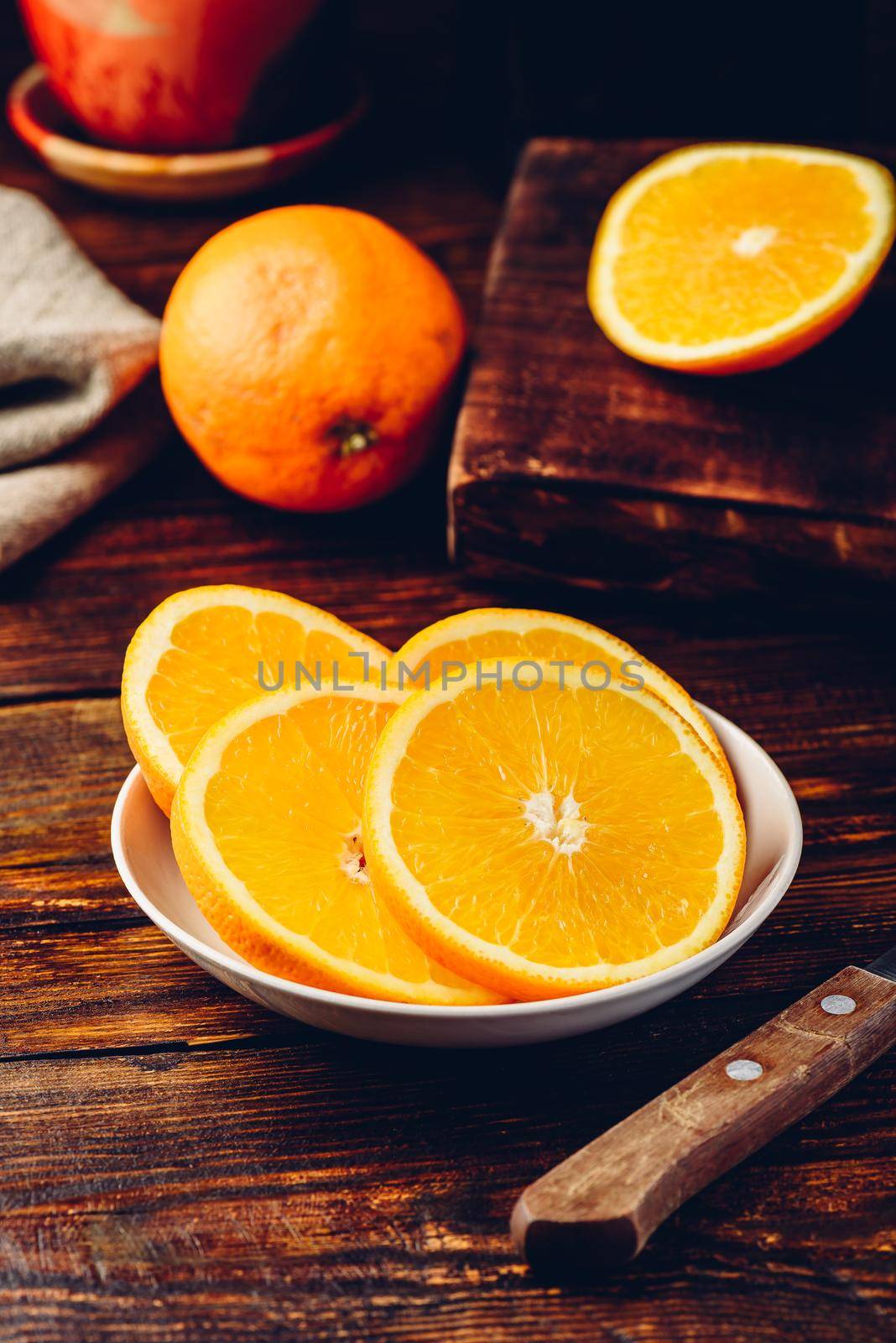 Slices of orange on white plate by Seva_blsv