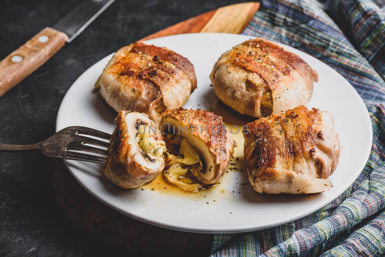 Bacon-wrapped button mushrooms stuffed with grated cheddar cheese and spices