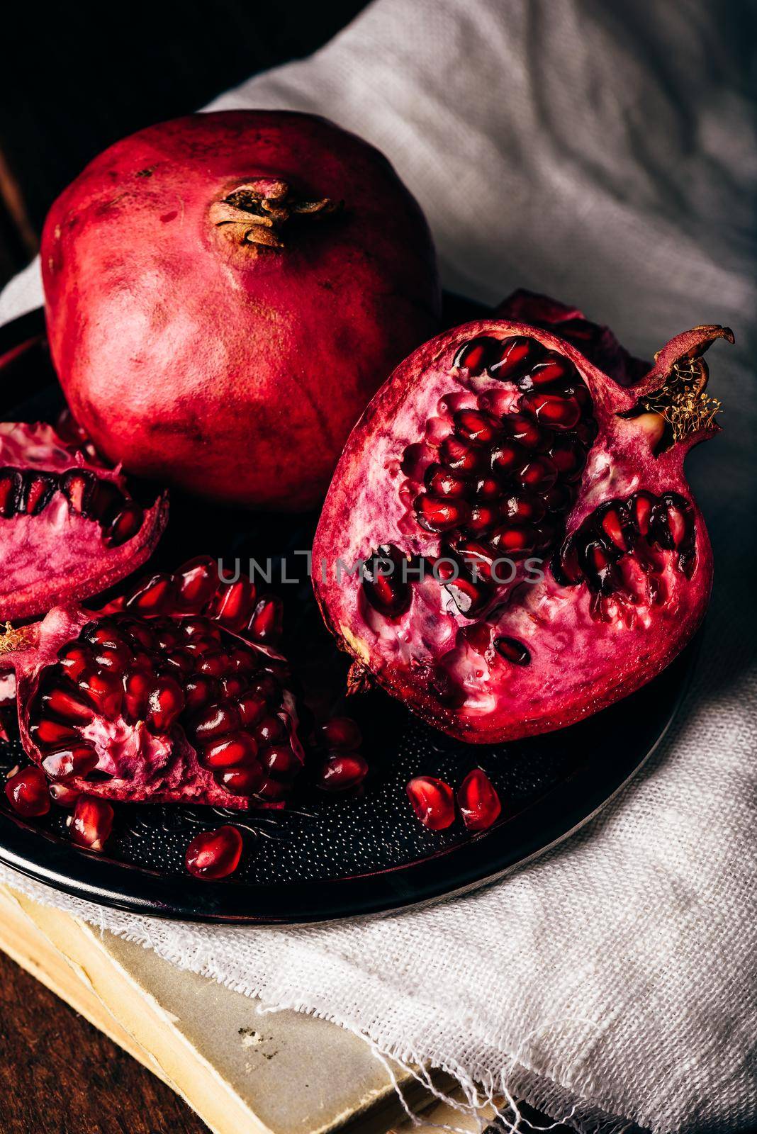 Ripe and juicy pomegranate fruit on metal plate