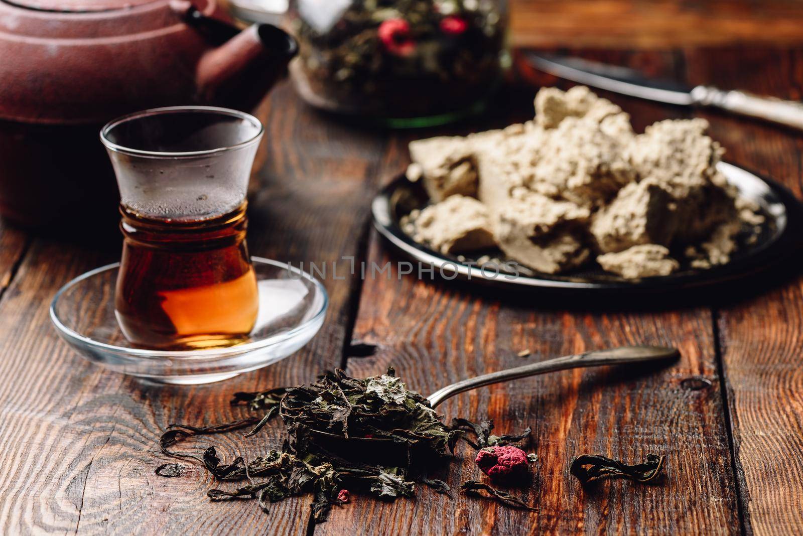 Spoonful of raspberry herbal tea and ready tea in armudu glass by Seva_blsv