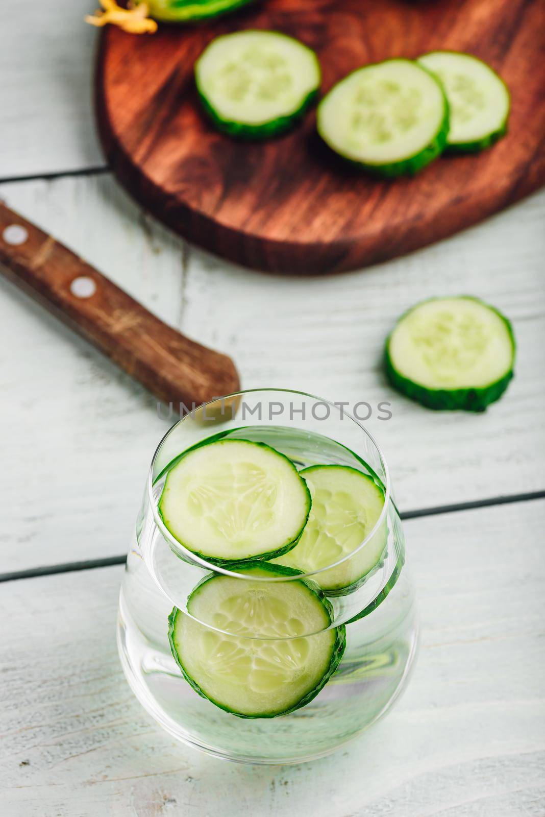Water infused with sliced cucumber in a drinking glass