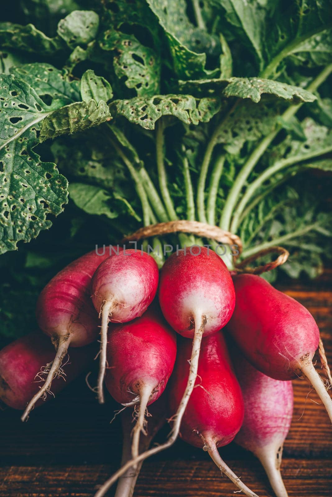 Bunch of fresh red radish on wooden table